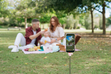 Recording family picnic moments with mobile phone