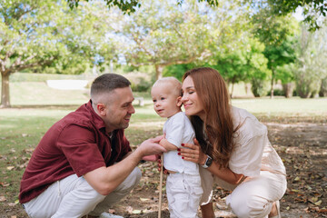 Loving parents interacting with toddler in park