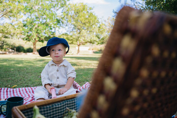 Toddler enjoying picnic outdoors in summer park