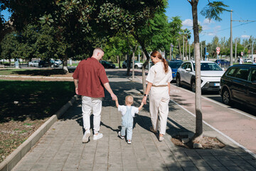 Family walking together on city sidewalk