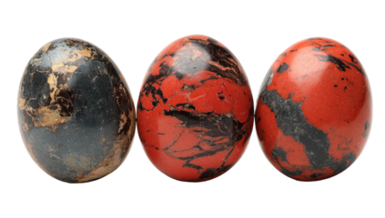 Three marbled, oval objects, with varied red, black, and gray colorations, arranged on black