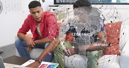 Pointing, man in red shirt leaning over sofa at office lounge, examining laptop swatches overlay