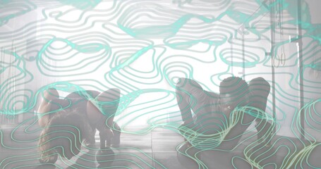 Two dancers performing floorwork in studio wearing dark athletic wear on wood floor, teal overlay