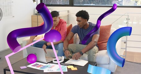 Working two men wearing red hoodie blue tee in loft reviewing laptop notebook swatches AR overlays