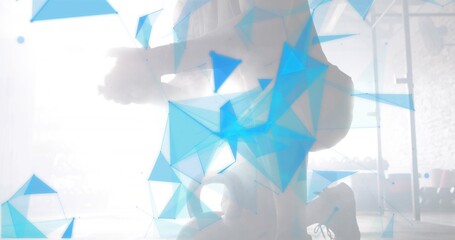 Training pair of adults wearing activewear performing squat at gym, with pull-up rack blue overlay