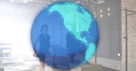 Performing partners in dark athletic wear stepping onto wooden plyo boxes at studio, globe overlay