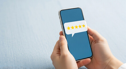 Hands holding a smartphone displaying a five-star rating in a speech bubble five stars