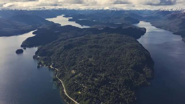 Spectacular aerial panorama of Lakes Nahuel Huapi, Correntoso, and Espejo with the snow-capped Andes Mountains in the background near Villa La Angostura, Patagonia