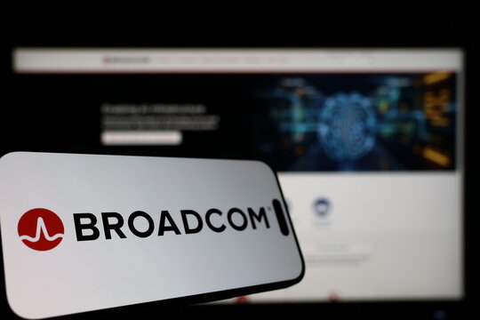 Kiel, Germany - 01-12-2026: Smartphone displaying Broadcom logo in front of the company website on a monitor