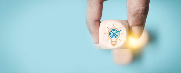 Focused business strategy concept. hand selecting idea block with light bulb target icon,...