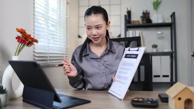 A Hispanic real estate agent uses a laptop to help a partner search online listings for a dream residential property.