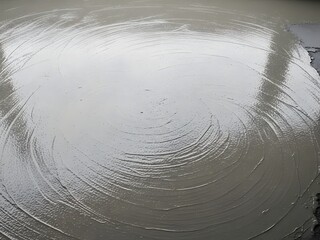 Aerial View of a Circular Concrete Site with Reflections