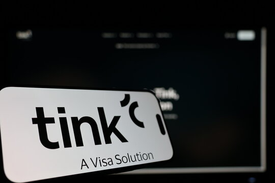 Kiel, Germany - 01-12-2026: Smartphone displaying Tink logo in front of the company website on a monitor