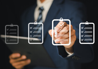 Businessman checking off tasks on a digital checklist on a tablet with a checkmark