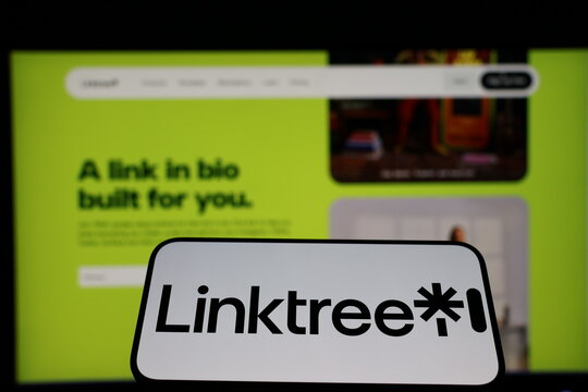 Kiel, Germany - 01-12-2026: Smartphone displaying Linktree logo in front of the company website on a monitor