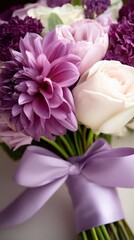 Obraz premium Close-up bouquet of pink, purple, and ivory flowers tied with a soft lavender ribbon. Soft glow on petals calm!