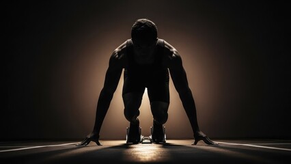 Silhouetted athlete in starting blocks, focus on the ground, backlit, dramatic lighting