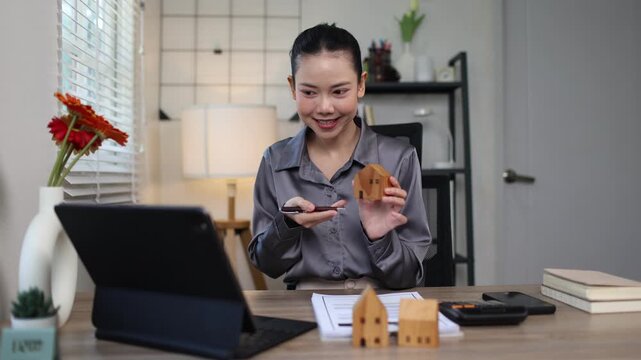 A Hispanic real estate agent uses a laptop to help a partner search online listings for a dream residential property.
