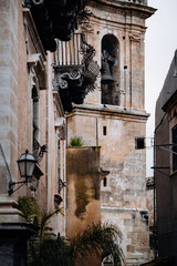 Historic Urban Architecture In Ragusa, Sicily: Weathered Stone Buildings, Narrow Streets, Layered Rooftops, And Church Dome Forming Dense Mediterranean Cityscape