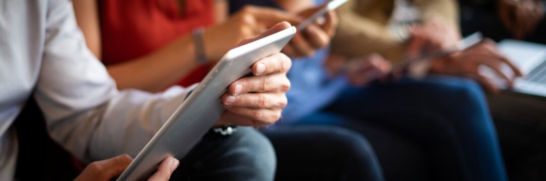 Close-up of diverse hands using tablets and smartphones. Technology and communication are key. Devices in focus, showing modern digital interaction. People using digital devices, social media. - Powered by Adobe