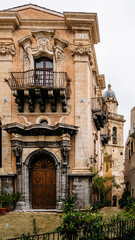 Historic Urban Architecture In Ragusa, Sicily: Weathered Stone Buildings, Narrow Streets, Layered Rooftops, And Church Dome Forming Dense Mediterranean Cityscape