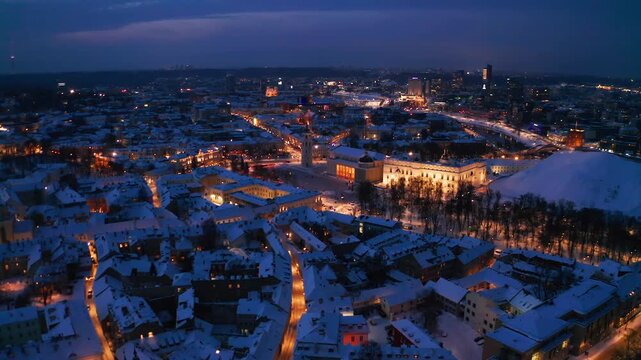  Late evening aerial view of downtown Vilnius with illuminated streets and city lights after sunset.
