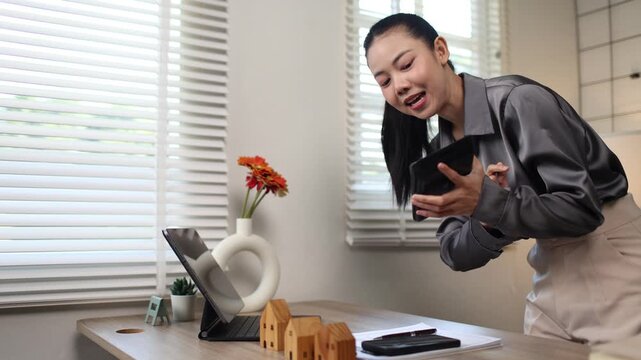 A Hispanic real estate agent uses a laptop to help a partner search online listings for a dream residential property.