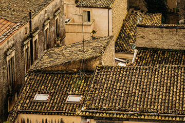 Panoramic View Over Ragusa From Cathedral Of San Giovanni Battista: Historic Sicilian City Rooftops, Church Domes, And Dense Stone Architecture Under Overcast Sky