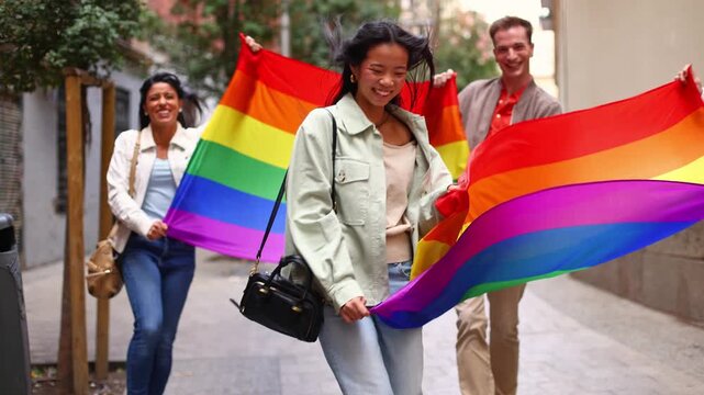 Diverse group of friends celebrating pride with rainbow flag
