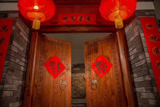 Traditional Chinese Doorway with Red Lanterns and New Year Decorations