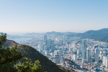 Busan cityscape from a mountain viewpoint showing urban sprawl and a busy port