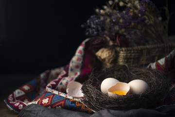 Fresh Eggs in Nest with Traditional Fabric Still Life
