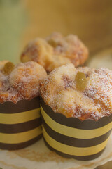 closeup three baked muffins (cupcakes) in In a brown and yellow patterned paper cup blur background, dessert, food, copy space