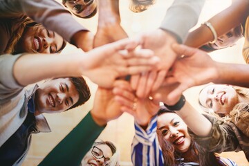 Diverse group of people, hands in unity, team spirit. Group of people, hands together, showing unity. Team spirit, diverse group, hands in unity, teamwork. Business team stacking hands together.