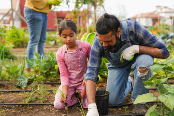 Indian father and daughter gardening together at house organic garden - Education, family lifestyle...