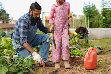 Indian father and daughter planting organic vegetable at huose garden - Family, education and...