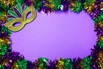 Bright colors and a festive mask set the stage for Mardi Gras fun on background with copy space