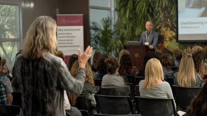 Medium shot of an expert speaking at a mental health seminar emphasizing professional insights and community education.