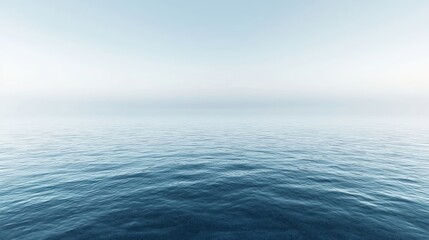 Obraz premium Blue, calm ocean under a hazy blue sky