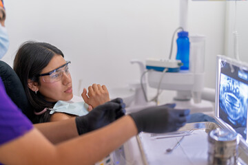 Dentist explaining dental x ray image to patient