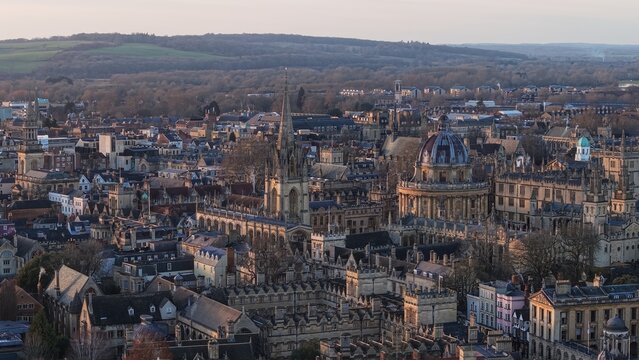 Oxford cityscape showing the Radcliffe Camera and other traditional university architecture at sunset