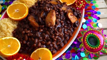 Traditional Brazilian Feijoada Black Bean Stew with Carnival Decorations and Festive Table Setting