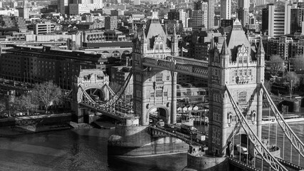 Tower Bridge connecting city banks across the River Thames in black and white