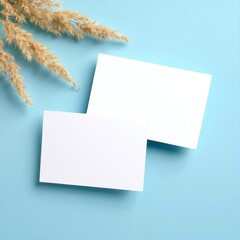 Two pristine white paper sheets lie flat on a vibrant blue background, showcasing their smooth texture and crisp edges, inviting creativity and ideas.