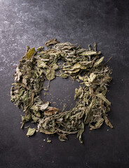 Dried mint leaves on black background, copy space