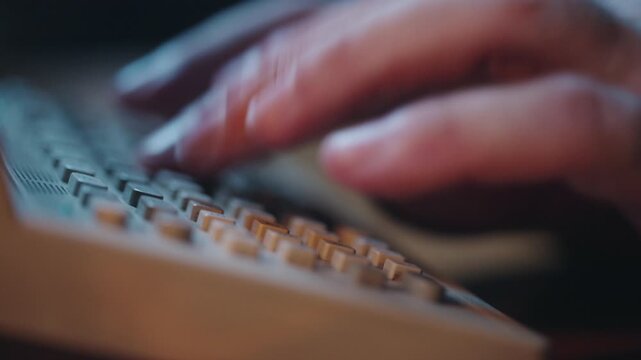 This footage showcases a close-up of a vintage computer keyboard, operated by a person, fa01