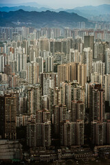 Fototapeta premium Dense Cityscape with Distant Mountains - Urban Aerial View