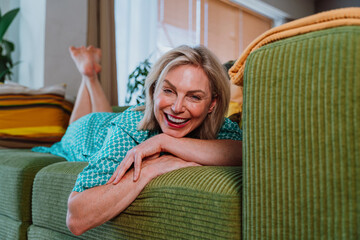 Happy senior woman relaxing on sofa at home