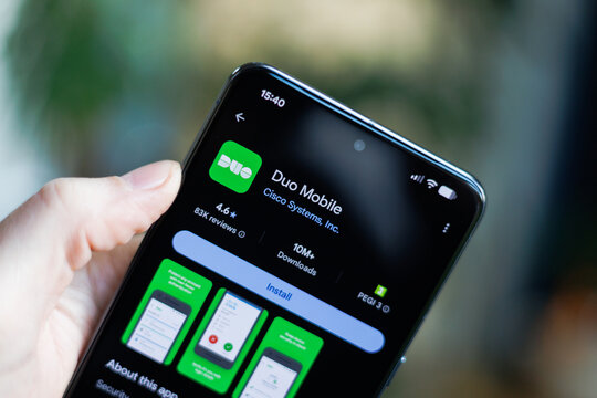 Phone in hand displaying Duo Mobile app on Google Play Store