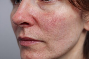Obraz premium Close View of a Womans Face Showing Skin Texture and Features in a Neutral Setting During Daylight Hours